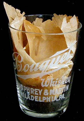 A Bouquet Whiskey glass recently denuded of its makers wrapper.